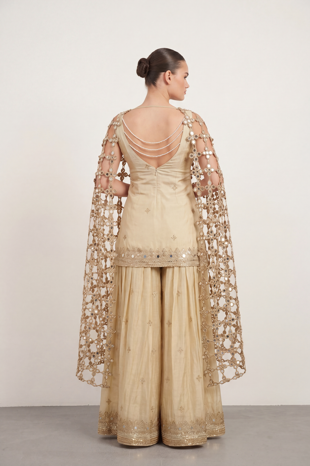 Gold mirrorwork sharara set — back view showing silhouette and finishing