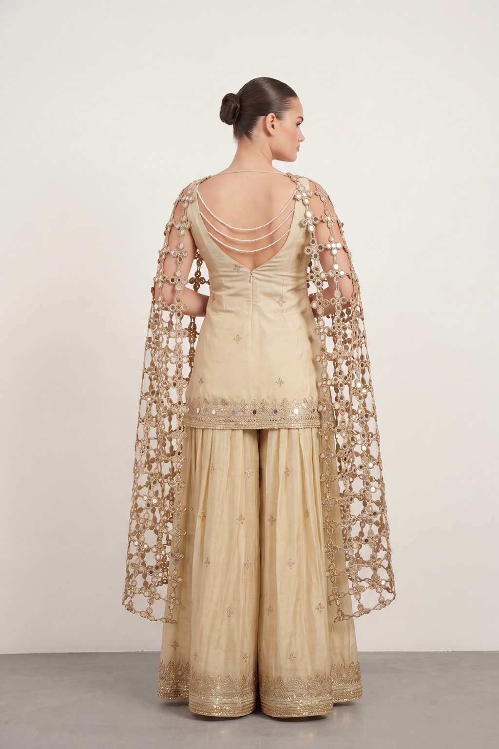 Gold mirrorwork sharara set — back view showing silhouette and finishing